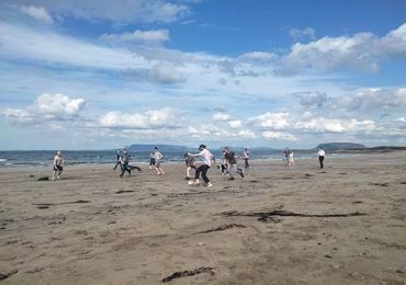 Woodrow team football on the beach  featured