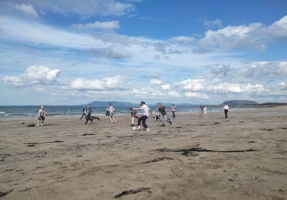 Woodrow team football on the beach  featured